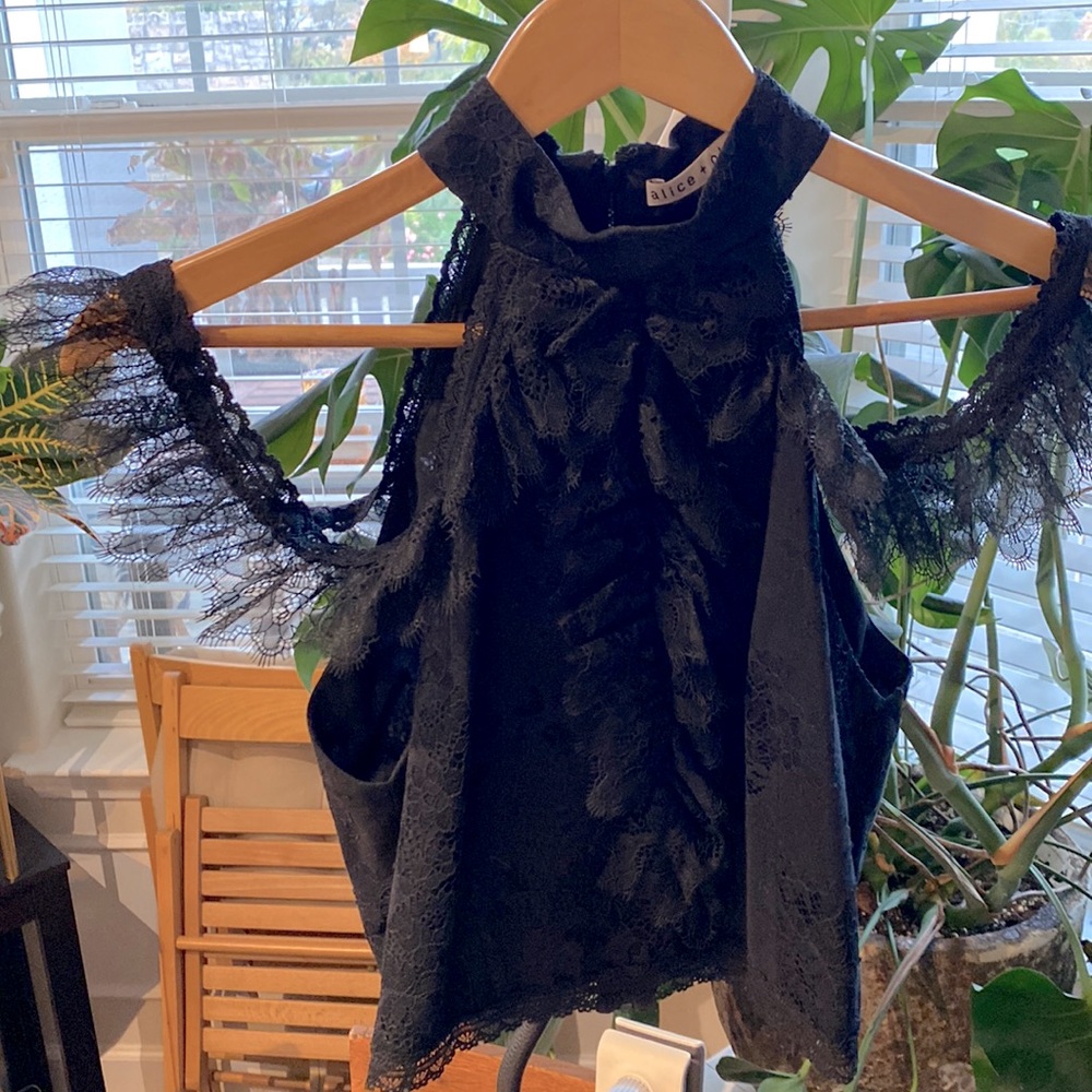 Black crop top blouse, zips up in the back, with fine lace detail